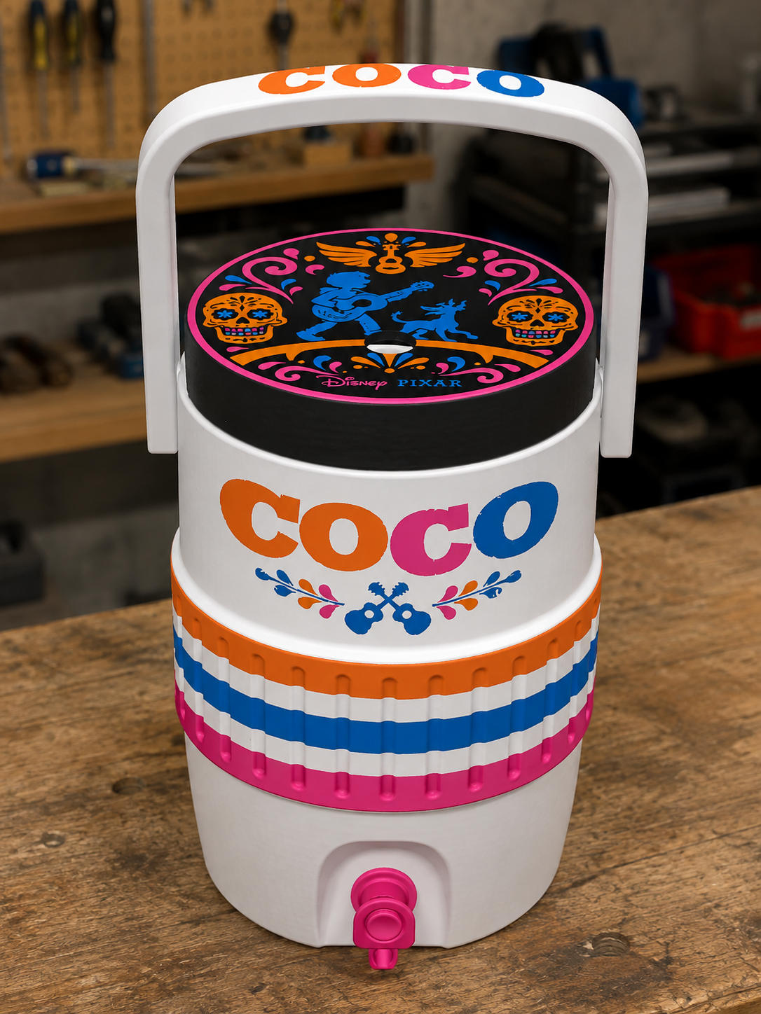 Disney Pixar Coco themed drink cooler jug with orange, blue, and pink colorways, sugar skull graphics, and Coco logo