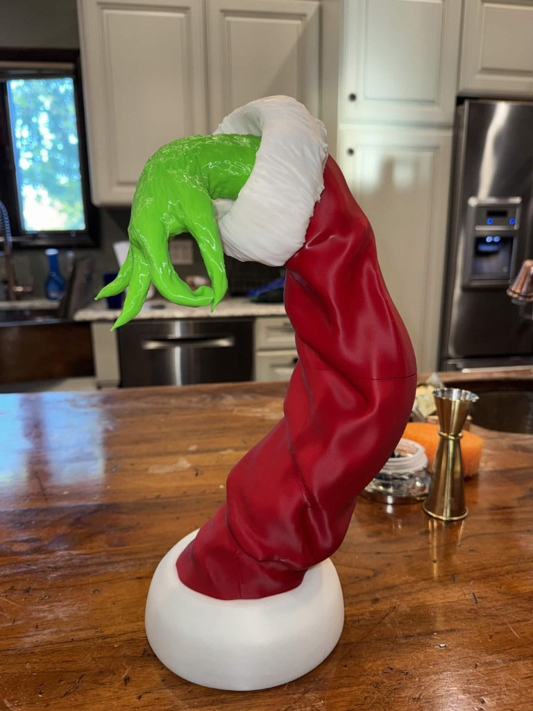 Real photo of the finished Grinch arm print on a kitchen counter, shown without an ornament