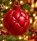 Ruby red 3D-printed tufted ball ornament hanging on a lit Christmas tree